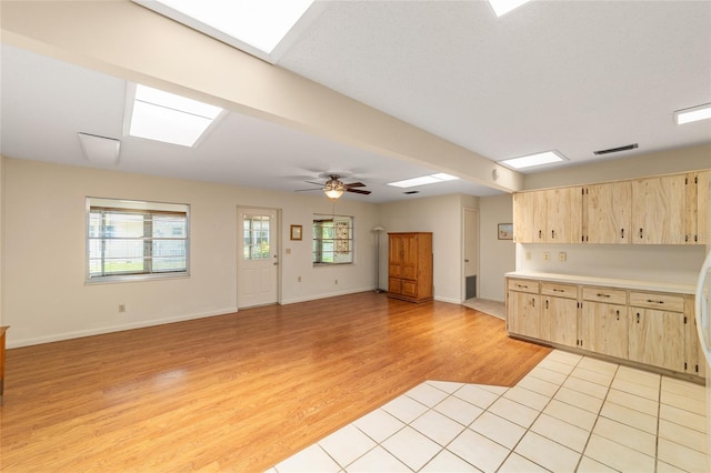 8704 SW 94th Ln Unit G, Ocala, FL 34481 - kitchen featuring light brown cabinets, light wood-type flooring, light countertops, and a skylight