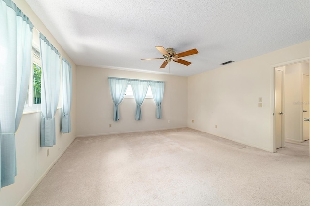8704 SW 94th Ln Unit G, Ocala, FL 34481 - spare room with plenty of natural light, light colored carpet, a ceiling fan, and a textured ceiling