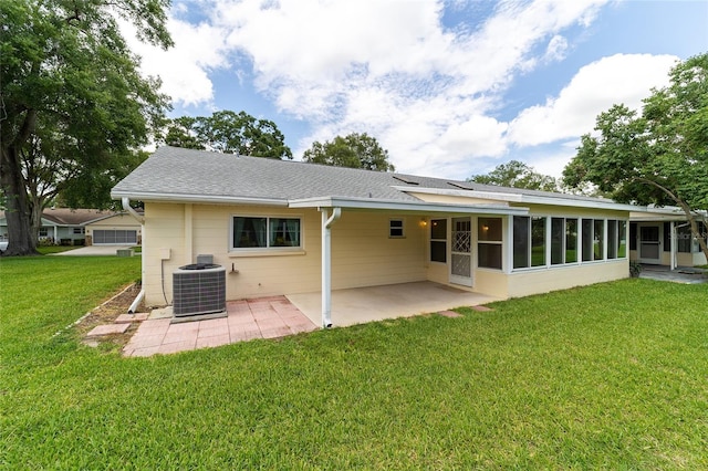 8704 SW 94th Ln Unit G, Ocala, FL 34481 - back of house featuring a patio area, a lawn, a sunroom, and roof with shingles