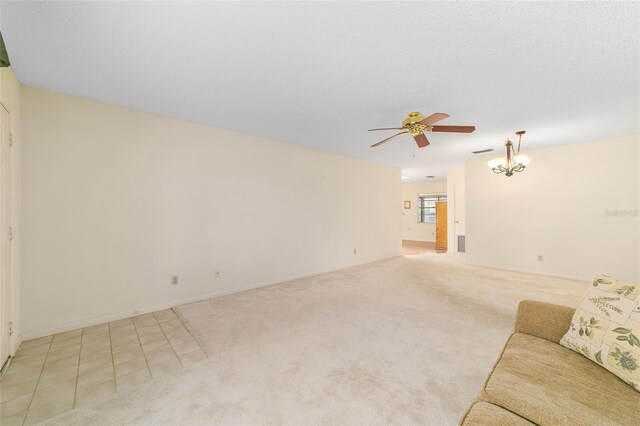 8704 SW 94th Ln Unit G, Ocala, FL 34481 - unfurnished living room with a ceiling fan, a chandelier, and light colored carpet