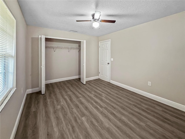 5 Bahia Circle Pl, Ocala, FL 34472 - unfurnished bedroom with dark wood-type flooring, a textured ceiling, a closet, and ceiling fan