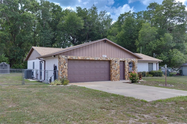 3427 SE 137th St, Summerfield, FL 34491 - view of front of property featuring a garage, stone siding, and driveway