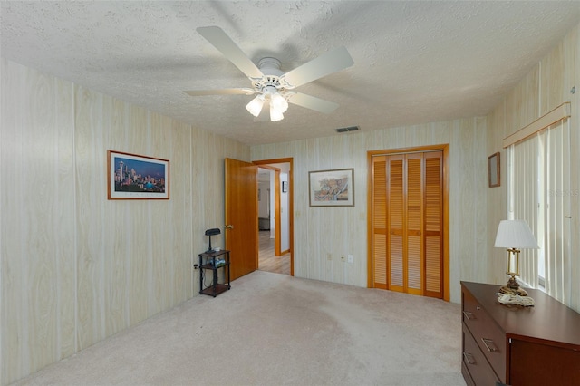3427 SE 137th St, Summerfield, FL 34491 - carpeted bedroom featuring a closet, a textured ceiling, and a ceiling fan
