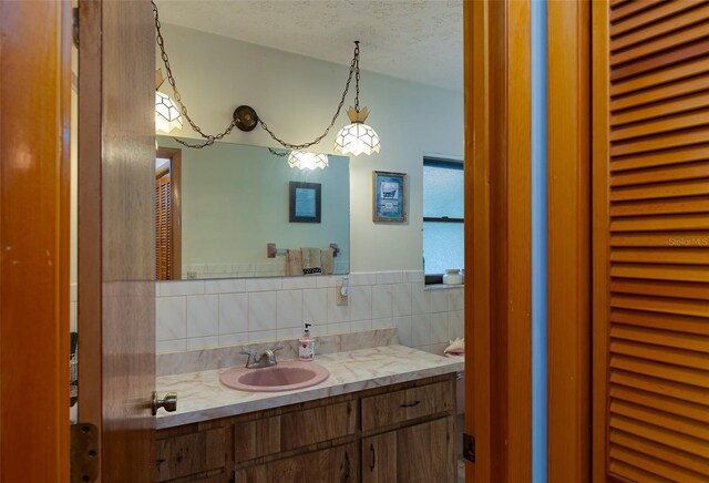 3427 SE 137th St, Summerfield, FL 34491 - bathroom featuring vanity, a textured ceiling, decorative backsplash, and lofted ceiling