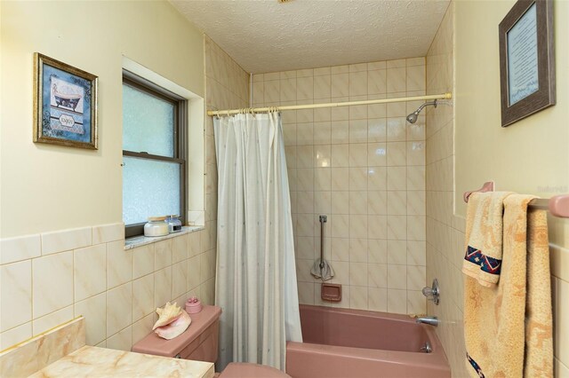 3427 SE 137th St, Summerfield, FL 34491 - full bathroom featuring shower / tub combo with curtain, a textured ceiling, vanity, and tile walls