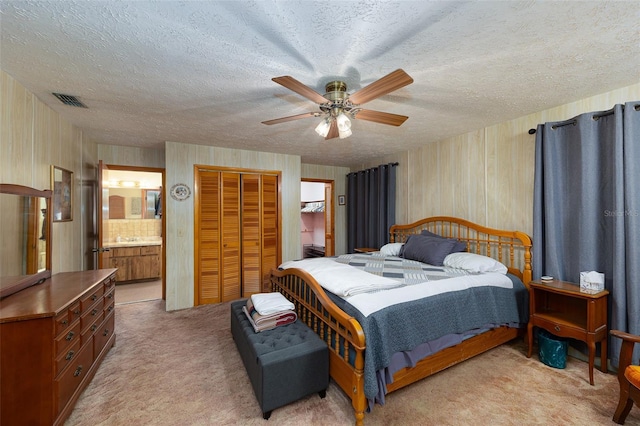 3427 SE 137th St, Summerfield, FL 34491 - bedroom with light carpet, a textured ceiling, ensuite bath, a ceiling fan, and a closet