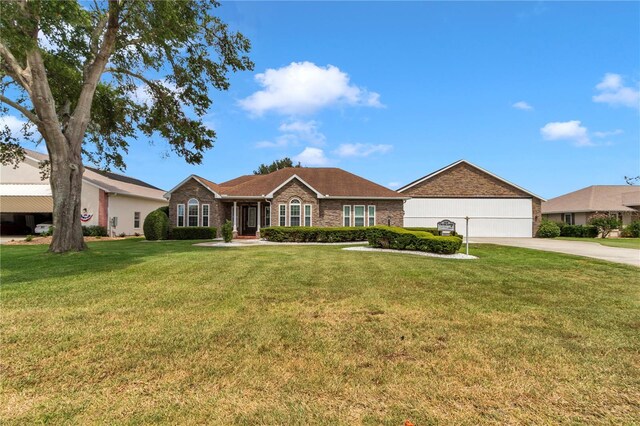 9641 SE 70th Ter, Ocala, FL 34472 - single story home with a front yard, concrete driveway, and brick siding