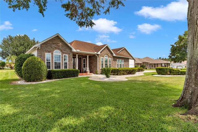9641 SE 70th Ter, Ocala, FL 34472 - single story home featuring a front yard, brick siding, and stone siding