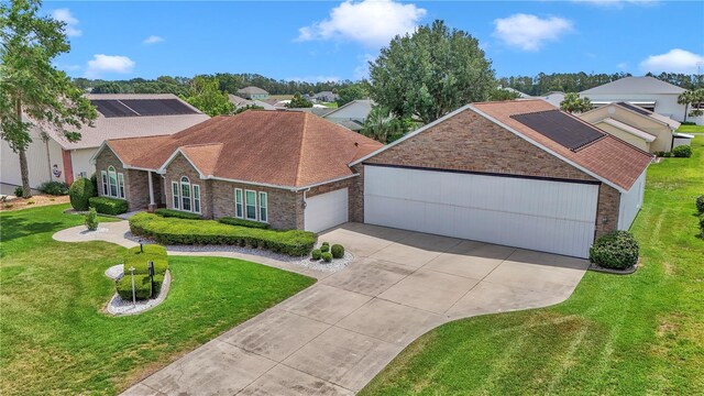 9641 SE 70th Ter, Ocala, FL 34472 - ranch-style home featuring a garage, concrete driveway, stone siding, a front lawn, and roof with shingles