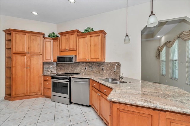 9641 SE 70th Ter, Ocala, FL 34472 - kitchen featuring stainless steel appliances, a peninsula, decorative backsplash, light stone counters, and pendant lighting