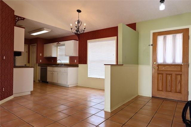 7 Pecan Drive Loop, Ocala, FL 34472 - kitchen with dishwashing machine, white cabinets, dark countertops, light tile patterned flooring, and a wainscoted wall