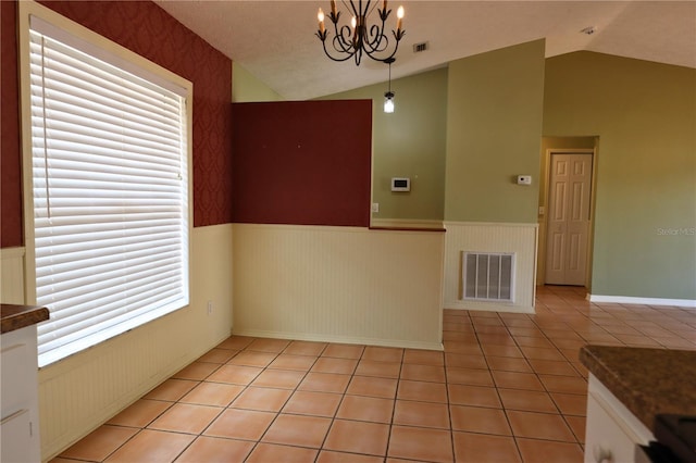 7 Pecan Drive Loop, Ocala, FL 34472 - unfurnished dining area with vaulted ceiling, a wainscoted wall, a chandelier, and light tile patterned floors