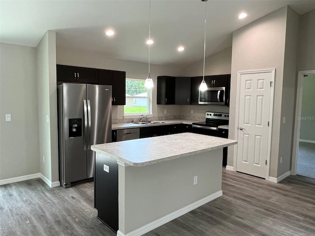 8795 Juniper Rd, Ocala, FL 34480 - kitchen featuring stainless steel appliances, dark cabinetry, light countertops, a center island, and vaulted ceiling