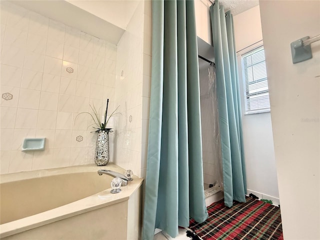 502 SE Guava Ter, Port St Lucie, FL 34983 - bathroom featuring a stall shower and a bath