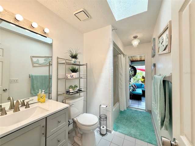 502 SE Guava Ter, Port St Lucie, FL 34983 - bathroom featuring tile patterned floors, vanity, a skylight, a textured ceiling, and shower / bath combo