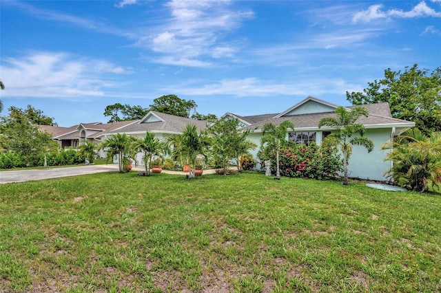 502 SE Guava Ter, Port St Lucie, FL 34983 - ranch-style house featuring driveway and a front lawn