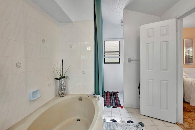 502 SE Guava Ter, Port St Lucie, FL 34983 - ensuite bathroom with a bath and tile patterned floors