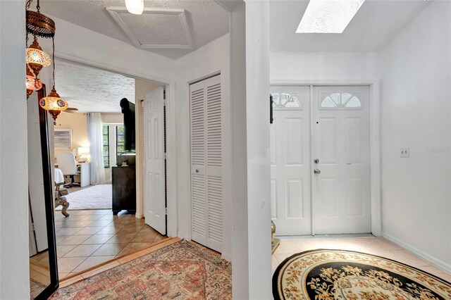 502 SE Guava Ter, Port St Lucie, FL 34983 - tiled entryway featuring a textured ceiling