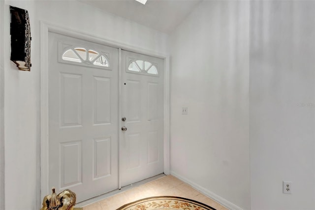 502 SE Guava Ter, Port St Lucie, FL 34983 - foyer with baseboards and light tile patterned floors
