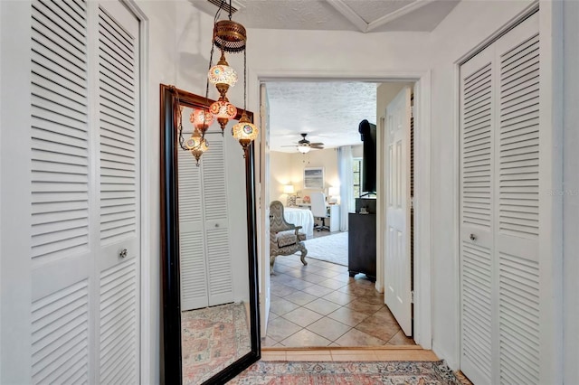 502 SE Guava Ter, Port St Lucie, FL 34983 - hall featuring light tile patterned flooring and a textured ceiling