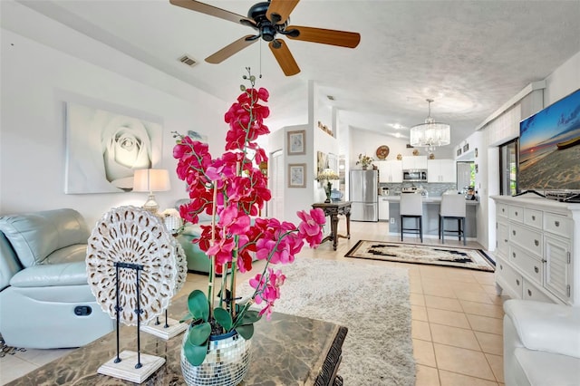 502 SE Guava Ter, Port St Lucie, FL 34983 - living area featuring a chandelier, light tile patterned flooring, and a ceiling fan