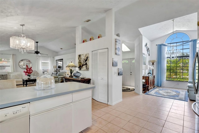 502 SE Guava Ter, Port St Lucie, FL 34983 - kitchen featuring vaulted ceiling, dishwasher, a chandelier, light tile patterned floors, and open floor plan