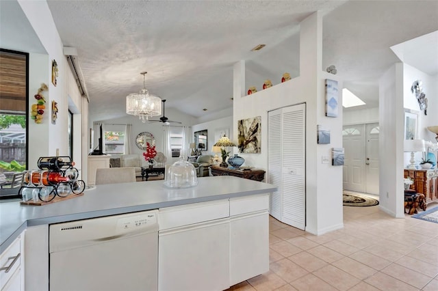 502 SE Guava Ter, Port St Lucie, FL 34983 - kitchen featuring white dishwasher, a chandelier, lofted ceiling, open floor plan, and light countertops