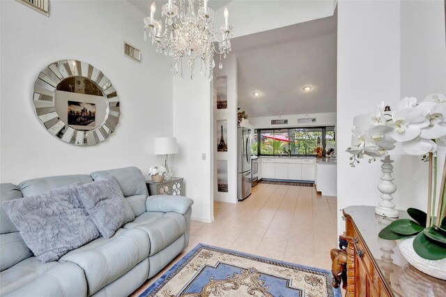 502 SE Guava Ter, Port St Lucie, FL 34983 - living room with a chandelier, light tile patterned floors, a towering ceiling, and recessed lighting