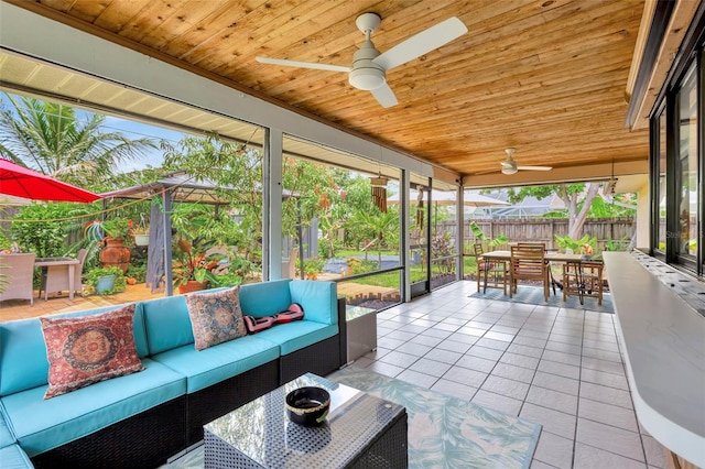 502 SE Guava Ter, Port St Lucie, FL 34983 - sunroom featuring ceiling fan, outdoor dining space, and an outdoor living space