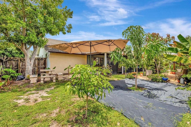 502 SE Guava Ter, Port St Lucie, FL 34983 - back of property featuring stucco siding and a patio