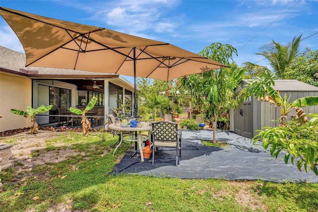 502 SE Guava Ter, Port St Lucie, FL 34983 - view of patio / terrace featuring ceiling fan, outdoor dining area, and a storage unit