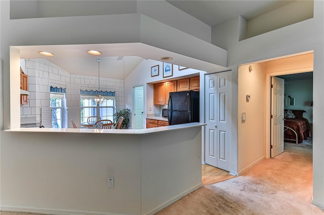 585 W Barrymore Dr, Beverly Hills, FL 34465 - kitchen with freestanding refrigerator, light carpet, a chandelier, brown cabinetry, and a peninsula