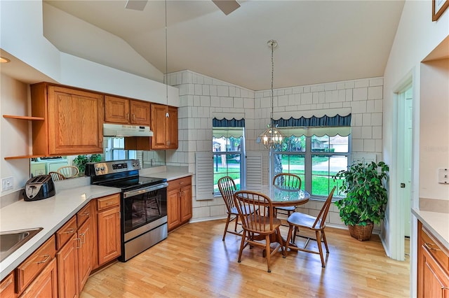 585 W Barrymore Dr, Beverly Hills, FL 34465 - kitchen featuring electric stove, under cabinet range hood, vaulted ceiling, plenty of natural light, and brown cabinetry