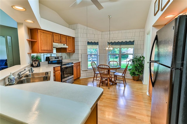 585 W Barrymore Dr, Beverly Hills, FL 34465 - kitchen with freestanding refrigerator, electric stove, under cabinet range hood, brown cabinets, and lofted ceiling