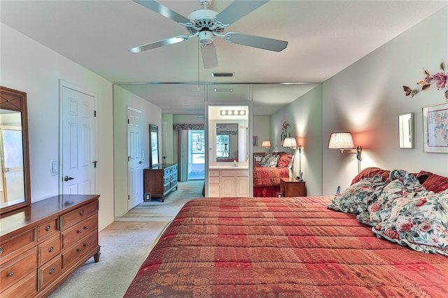 585 W Barrymore Dr, Beverly Hills, FL 34465 - bedroom featuring light colored carpet, ceiling fan, and ensuite bath