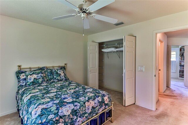 585 W Barrymore Dr, Beverly Hills, FL 34465 - bedroom with light colored carpet, a closet, and a ceiling fan