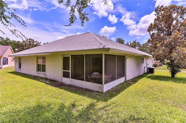 585 W Barrymore Dr, Beverly Hills, FL 34465 - back of property with a lawn, a sunroom, and stucco siding