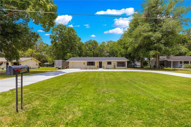 802 NE 39th Ct, Ocala, FL 34470 - single story home with concrete driveway, a front lawn, and an attached garage