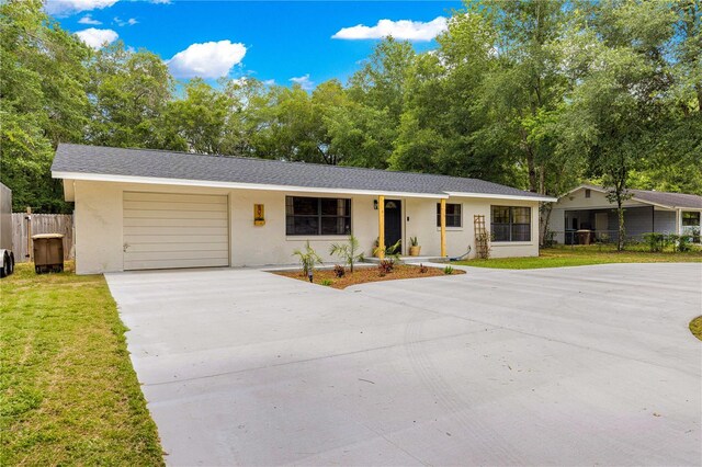 802 NE 39th Ct, Ocala, FL 34470 - ranch-style house featuring an attached garage, driveway, and stucco siding