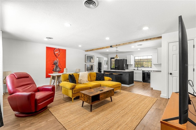 802 NE 39th Ct, Ocala, FL 34470 - living area featuring light wood-style floors, a textured ceiling, and recessed lighting