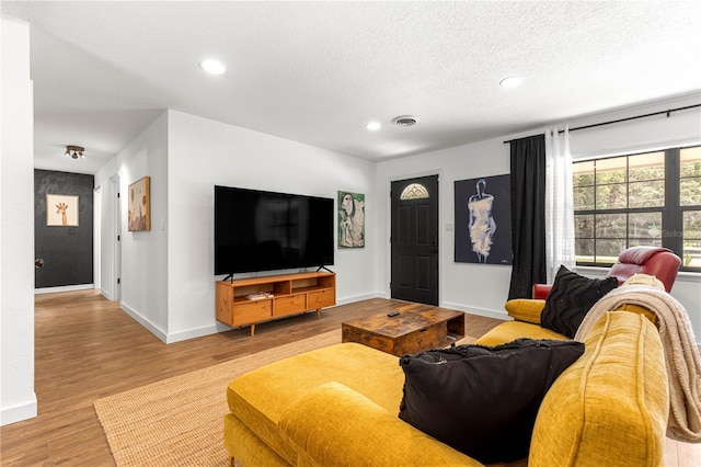 802 NE 39th Ct, Ocala, FL 34470 - living room with wood finished floors, recessed lighting, and a textured ceiling
