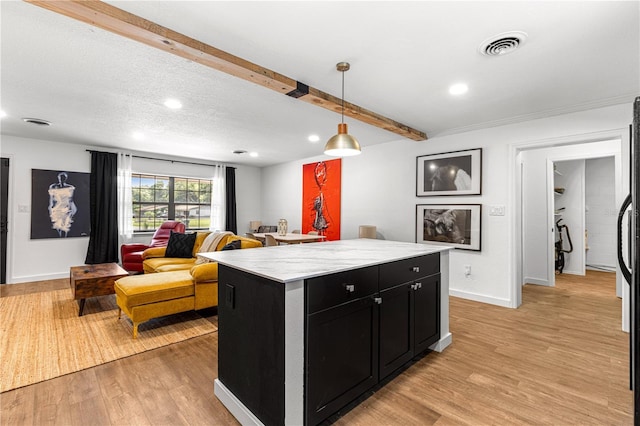 802 NE 39th Ct, Ocala, FL 34470 - kitchen with dark cabinetry, light wood-type flooring, a kitchen island, hanging light fixtures, and beam ceiling