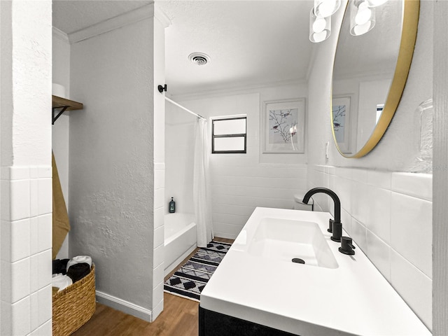 802 NE 39th Ct, Ocala, FL 34470 - bathroom with wood finished floors, crown molding, shower / bath combo, and vanity