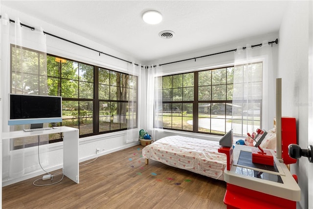 802 NE 39th Ct, Ocala, FL 34470 - bedroom featuring multiple windows and wood finished floors