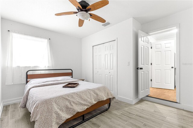 802 NE 39th Ct, Ocala, FL 34470 - bedroom with light wood finished floors, a closet, and a ceiling fan