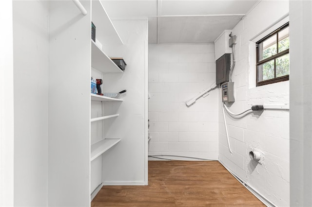 802 NE 39th Ct, Ocala, FL 34470 - bathroom featuring electric panel, wood finished floors, and concrete block wall