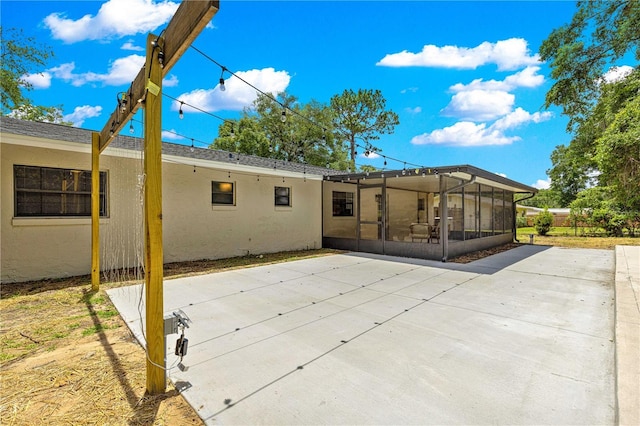802 NE 39th Ct, Ocala, FL 34470 - rear view of property with a sunroom, stucco siding, and a patio