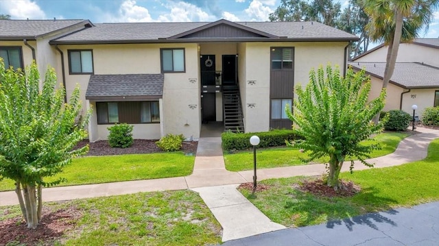 683 Midway Dr Unit B, Ocala, FL 34472 - view of property with a front yard, stucco siding, and a shingled roof