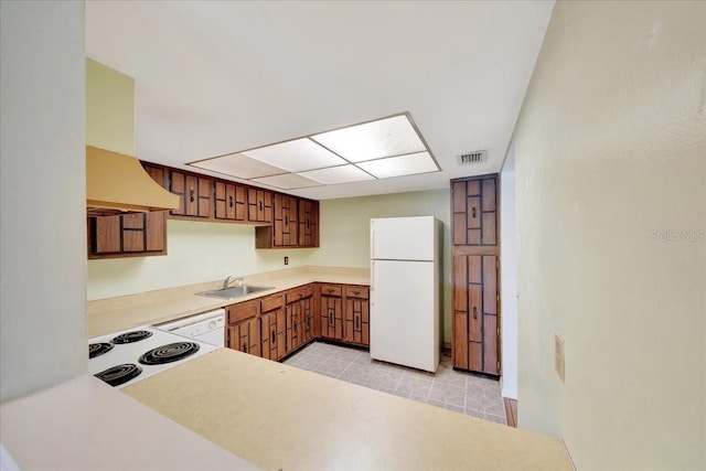 683 Midway Dr Unit B, Ocala, FL 34472 - kitchen with white appliances, premium range hood, light countertops, and brown cabinetry