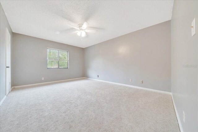 683 Midway Dr Unit B, Ocala, FL 34472 - empty room with a ceiling fan, light colored carpet, and a textured ceiling